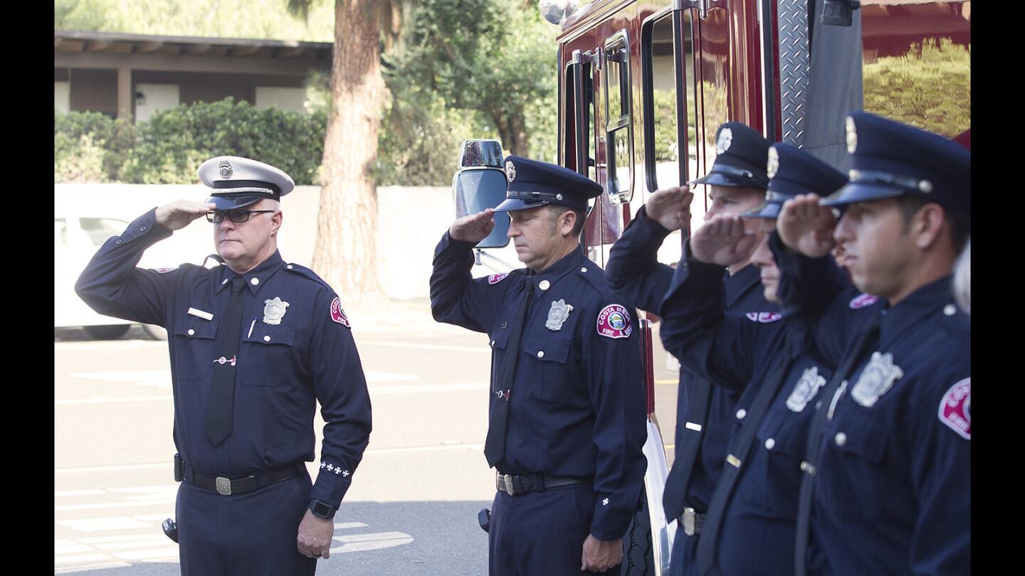 Costa Mesa firefighters, including Capt. Lenny Goodsir and Engineer Steve Cathey, at left, salute during a moment of silence to commemorate the 16th anniversary of Sept. 11, 2001, at station 5 headquarters in Costa Mesa on Monday.