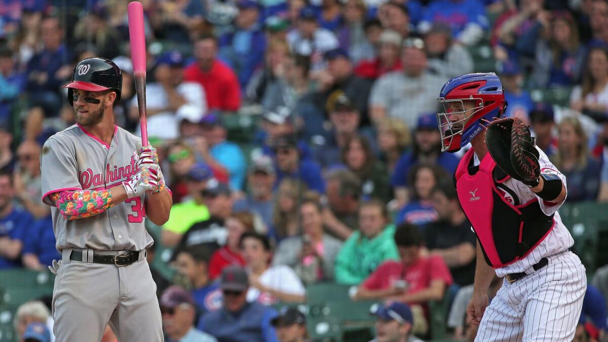 Chicago Cubs catcher David Ross waits for the pitch as Washington's Bryce Harper is intentionally walked on May 8.