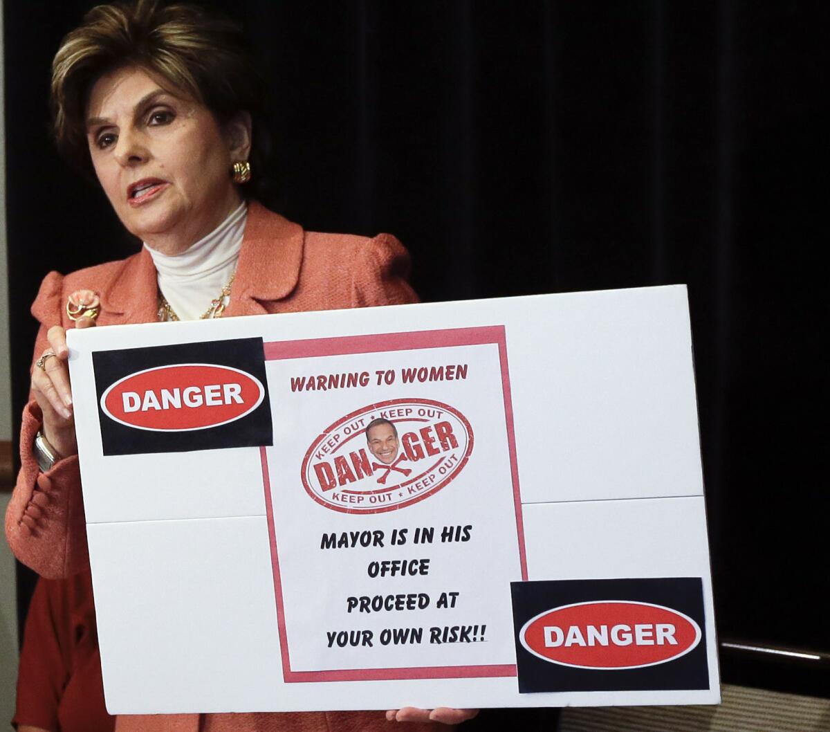 Attorney Gloria Allred holds a sign alluding to San Diego Mayor Bob Filner during a news conference on Tuesday in San Diego.