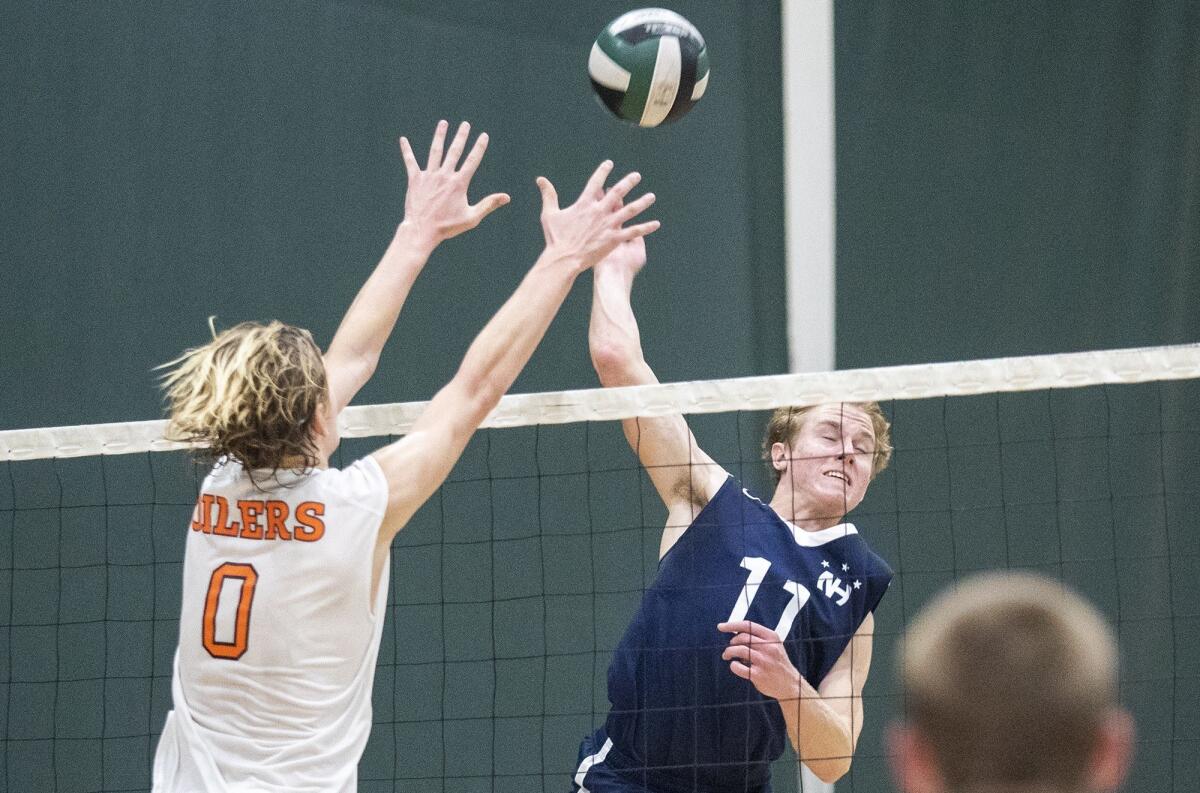 Newport Harbor High's Jack Higgs (11), seen hitting into Huntington Beach's Niko Colburn on March 2, helped the Sailors improve to 14-0 with Wednesday's sweep over Tesoro.