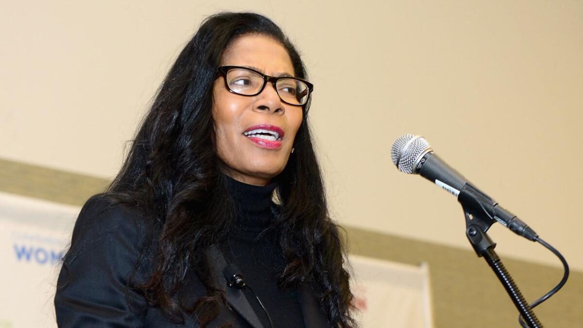 Judy Smith speaks into a microphone