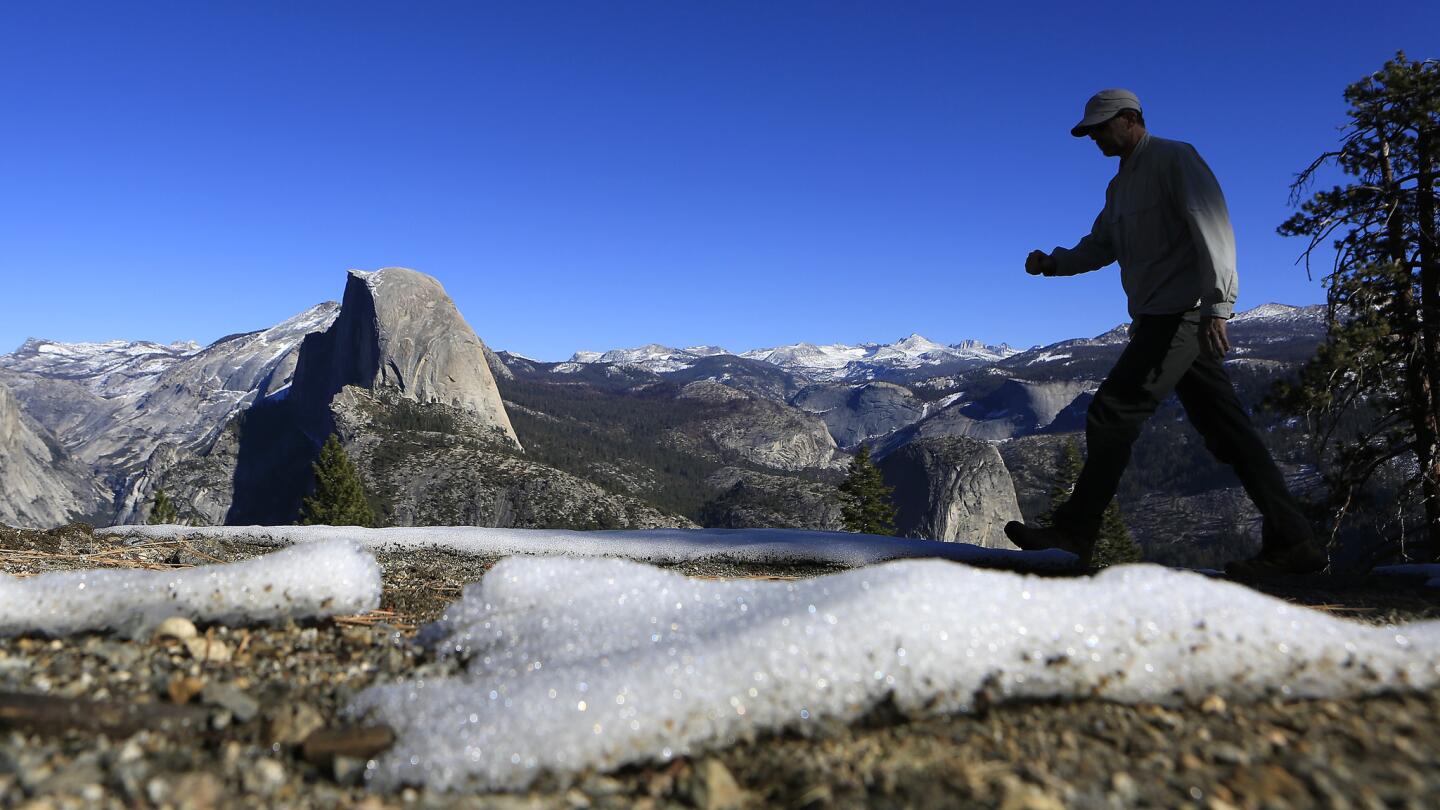 Darrell Carlis, 55, of Fresno hikes pat small patches of snow near the Panorama Trail. "We will conceivably see more years like this in the future," said geologist Jeffrey Mount, a senior fellow at the Public Policy Institute of California.