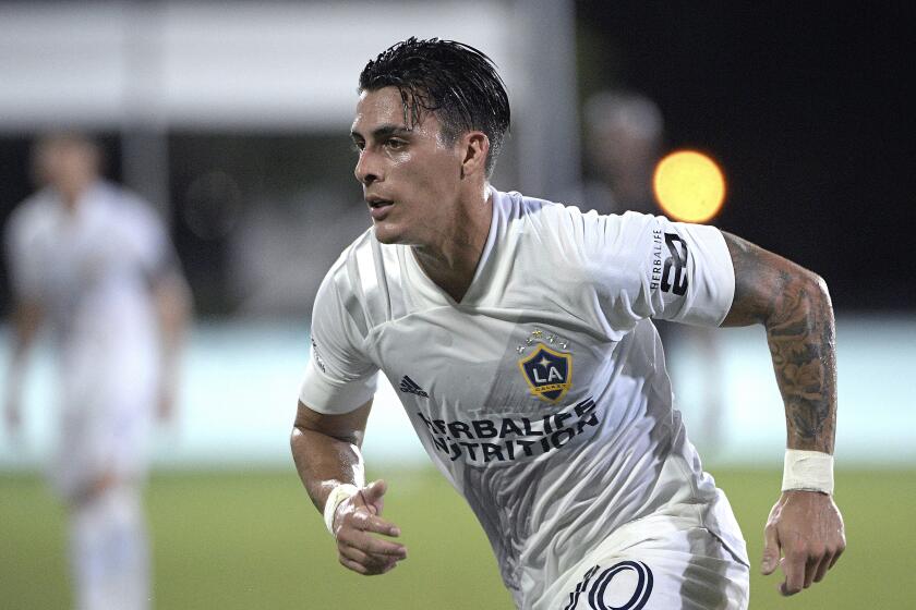 LA Galaxy forward Cristian Pavon (10) follows a play during the first half of an MLS soccer match against the Los Angeles FC, Saturday, July 18, 2020, in Kissimmee, Fla. (AP Photo/Phelan M. Ebenhack)