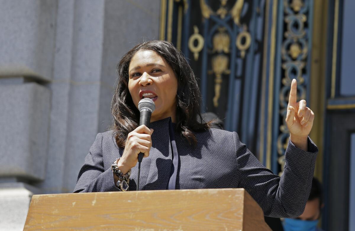 Mayor London Breed speaks outside City Hall in San Francisco.