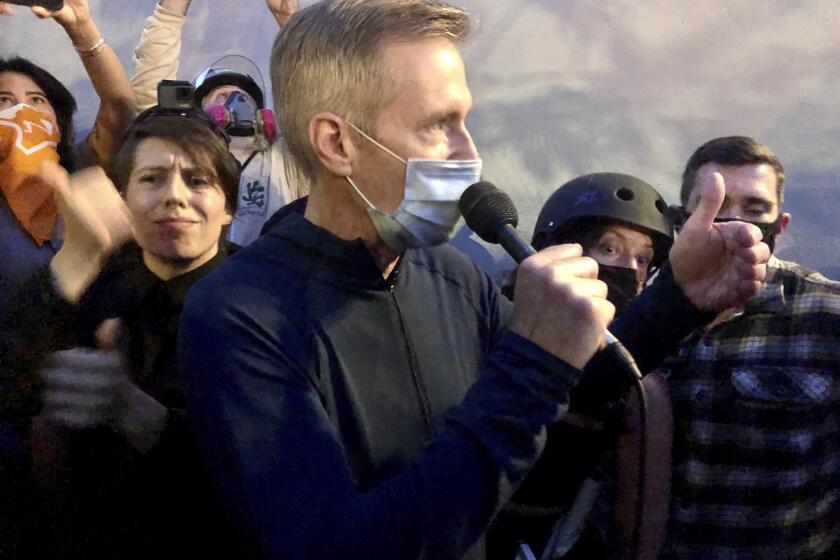 Mayor Ted Wheeler addresses a crowd in downtown Portland, Ore., on Wednesday.