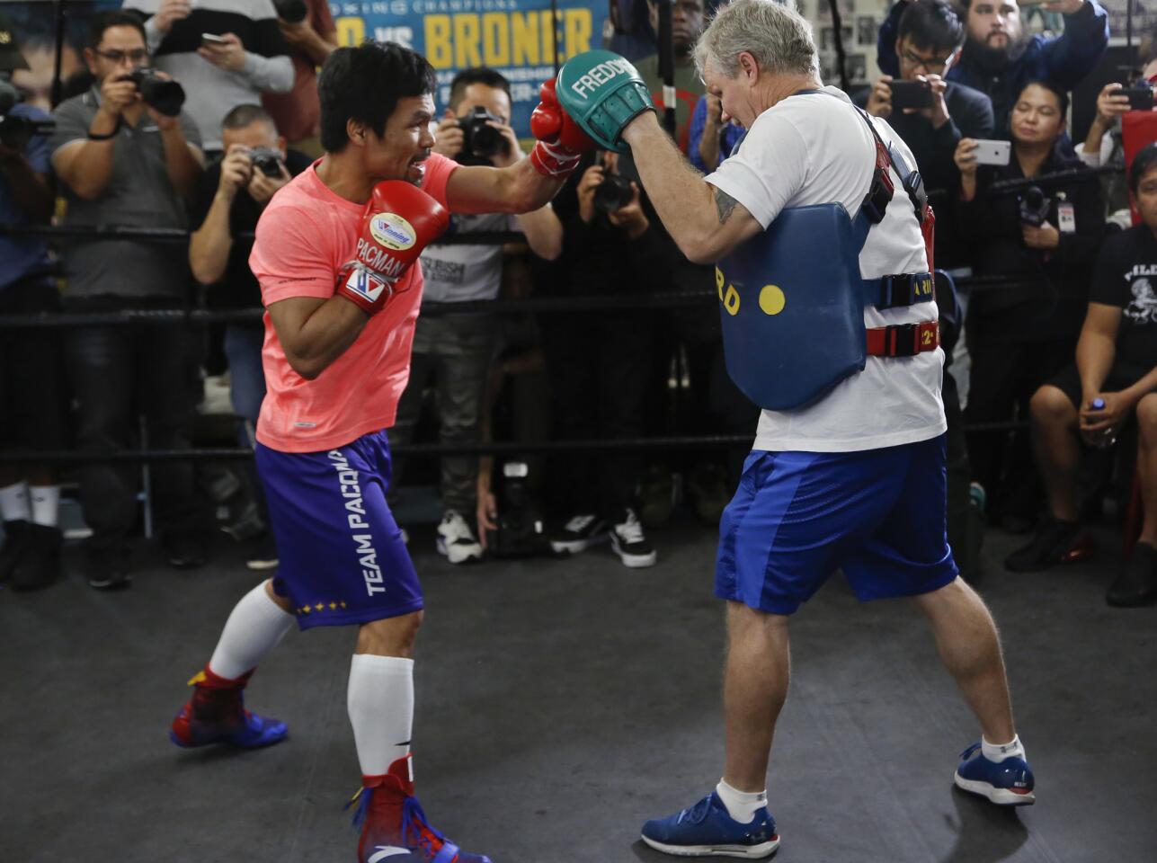 Manny Pacquiao, left, works out with trainer Freddie Roach at a boxing club in Los Angeles, Wednesday, Jan. 9, 2019. Pacquiao is scheduled to defend his WBA welterweight title against Adrien Broner on Jan. 19, 2019, in Las Vegas. (AP Photo/Damian Dovarganes)