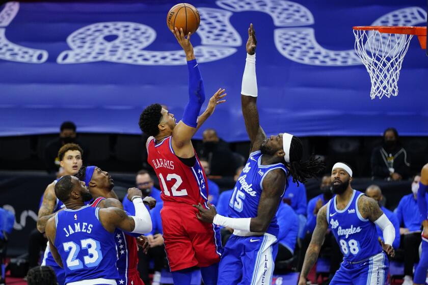 Philadelphia 76ers' Tobias Harris (12) goes up for a shot against Los Angeles Lakers' Montrezl Harrell (15) during the second half of an NBA basketball game, Wednesday, Jan. 27, 2021, in Philadelphia. (AP Photo/Matt Slocum)