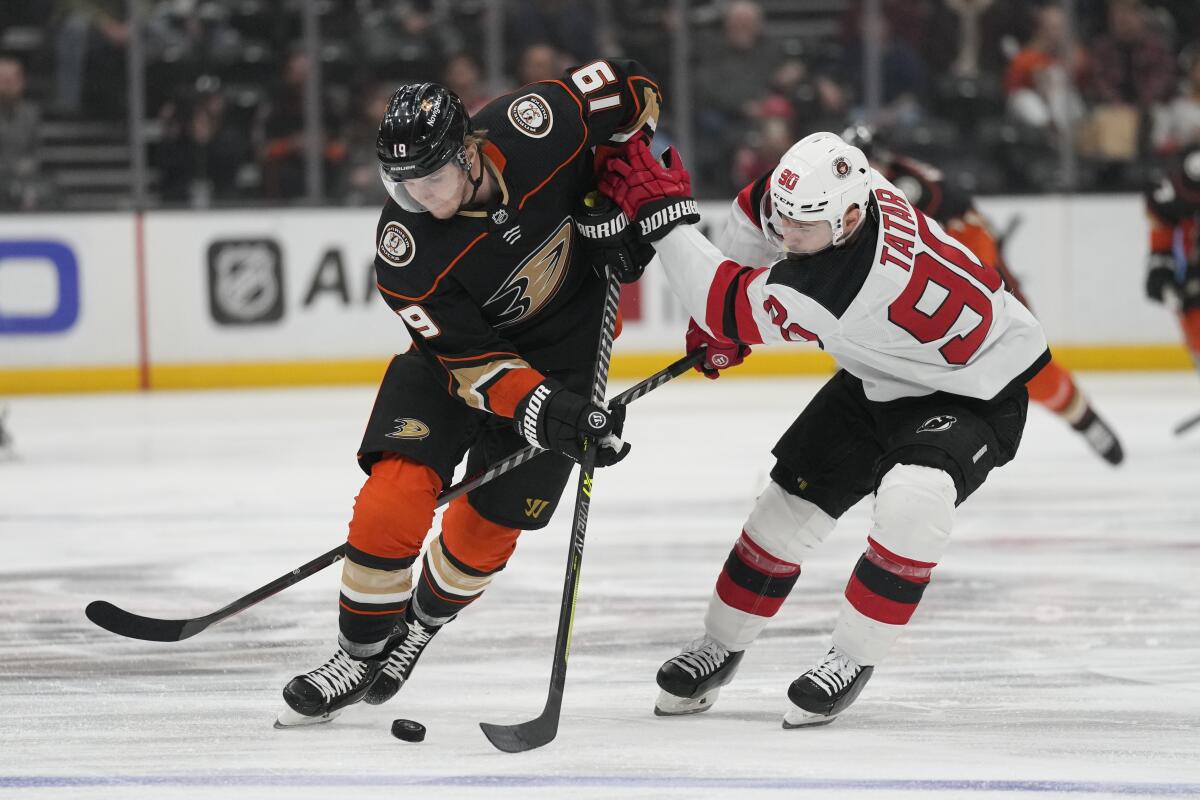 Ducks forward Troy Terry controls the puck in front of New Jersey Devils forward Tomas Tatar.
