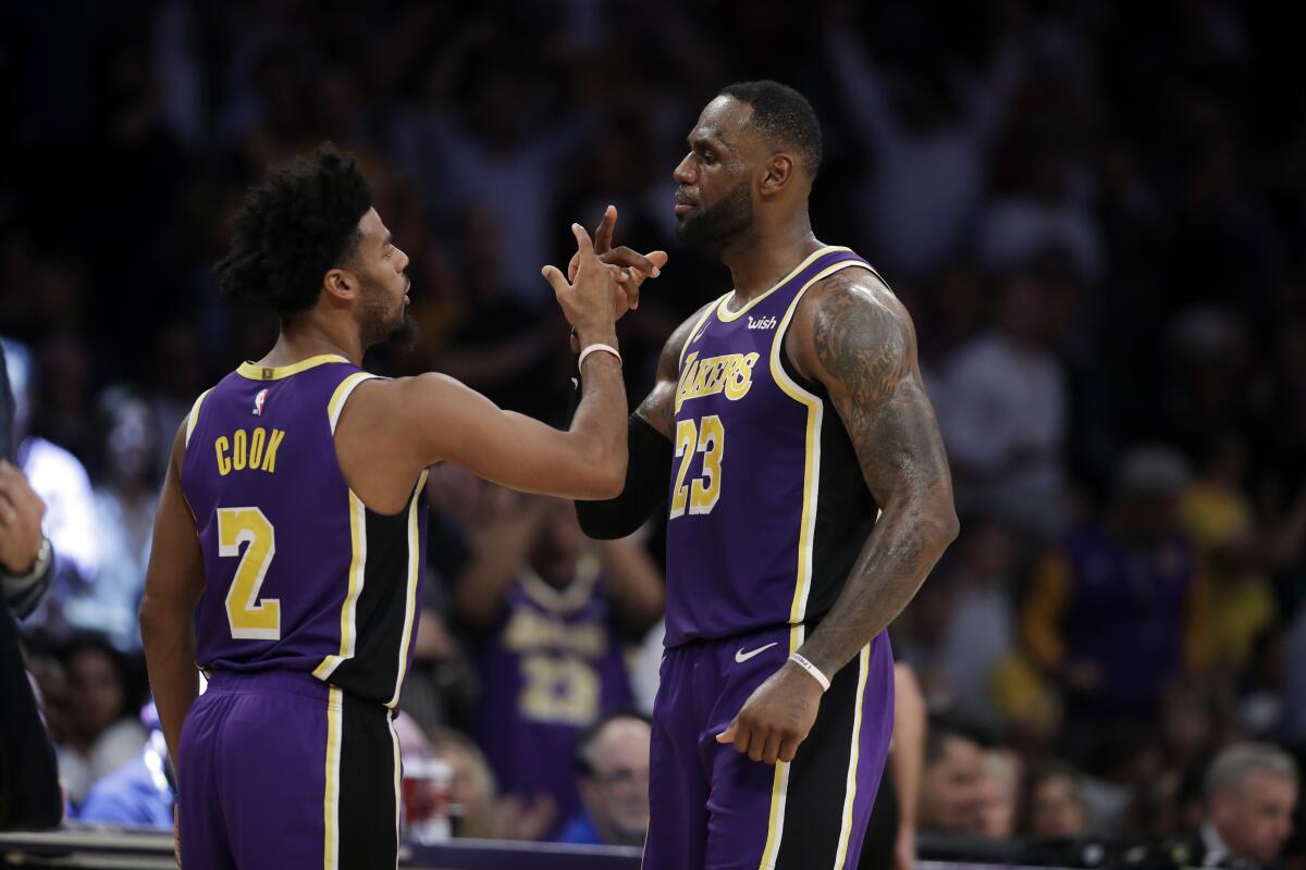 Lakers forward LeBron James celebrates with teammate Quinn Cook