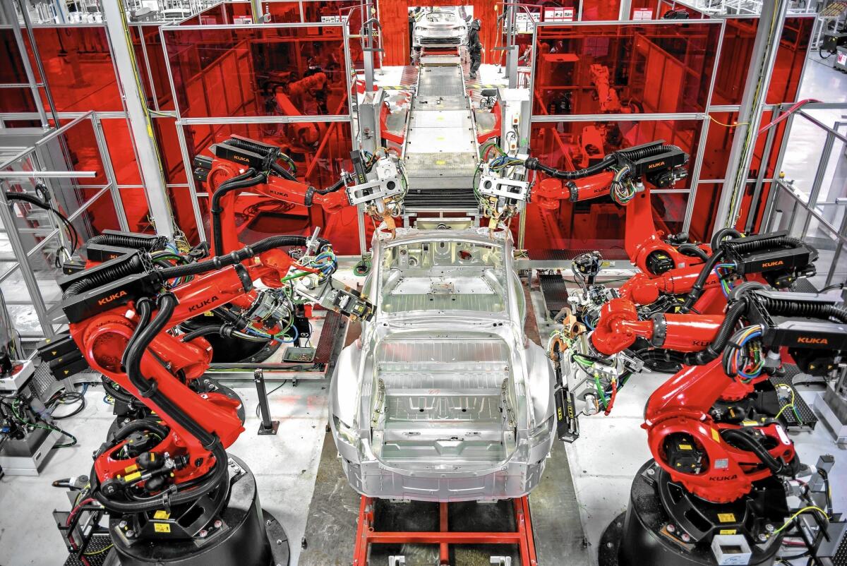 Robots assemble Model S sedans at Tesla's 5.3-million-square-foot plant in Fremont, Calif.