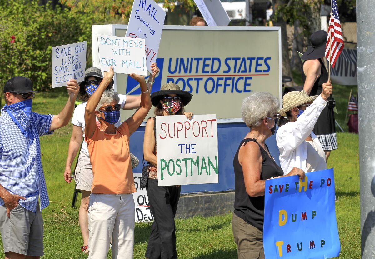 Protesters gathering in support of the USPS on Saturday near the Encinitas post office.