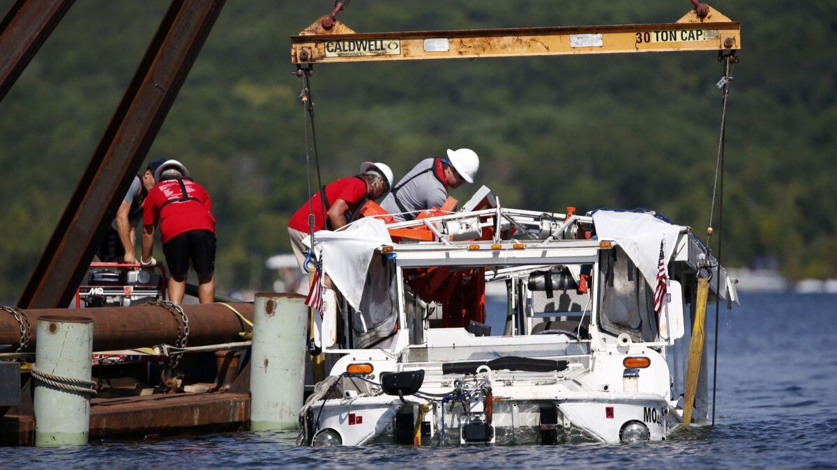 The duck boat that sank in Table Rock Lake in Branson, Mo., is raised Monday, July 23, 2018. The boat went down Thursday evening after a thunderstorm generated near-hurricane strength winds.