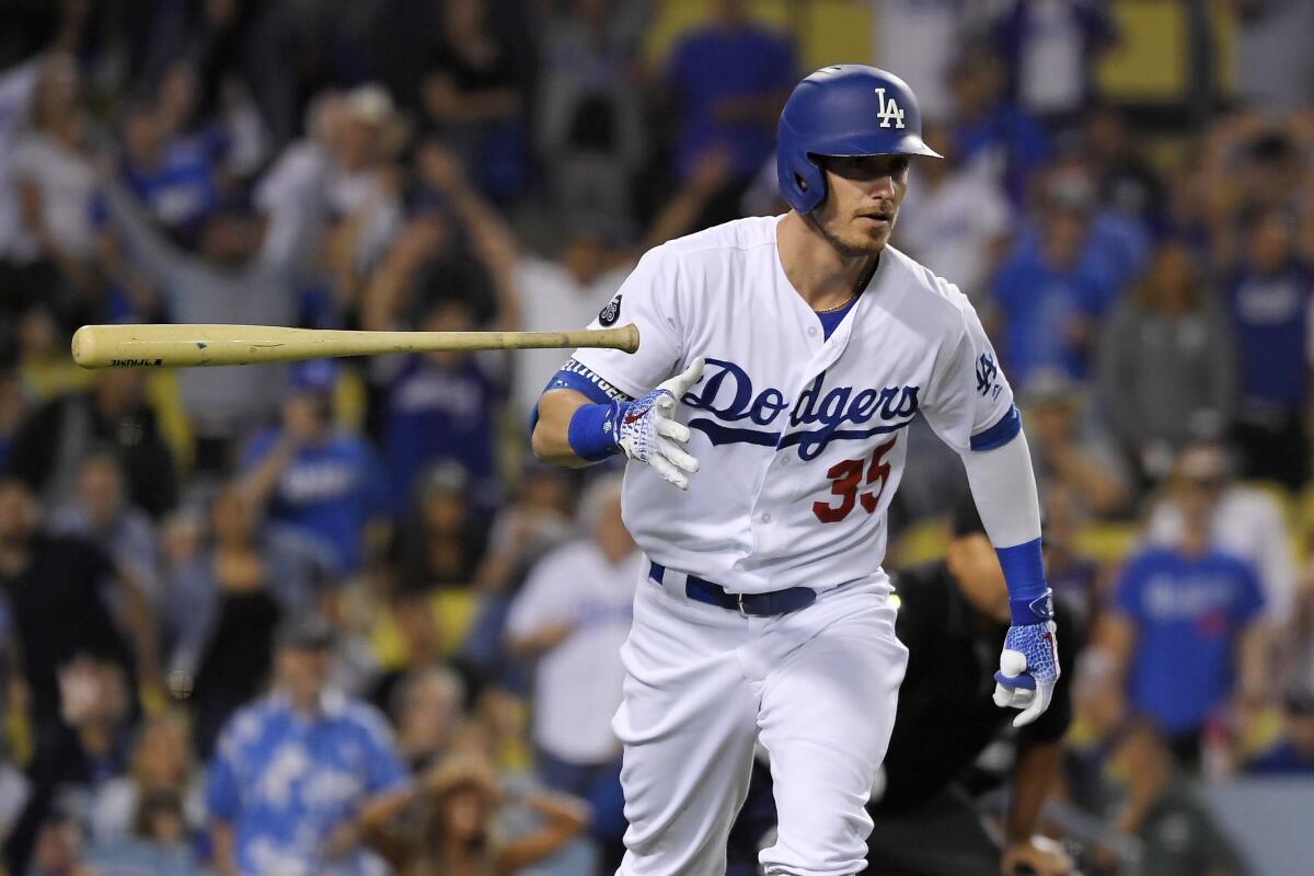 Dodgers' Cody Bellinger tosses his bat as he runs to first after hitting a solo home run during the eighth inning against the Tampa Bay Rays on Wednesday at Dodger Stadium.