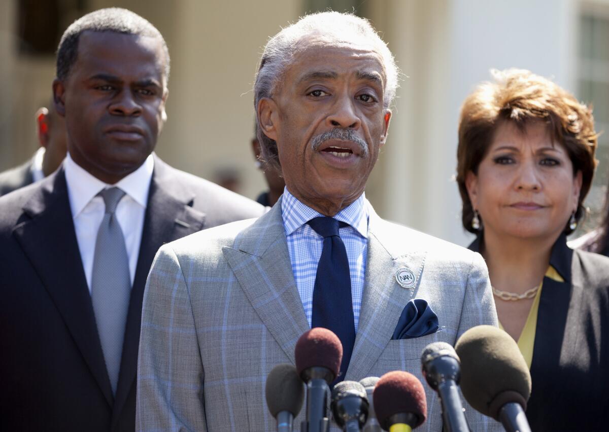 Rev. Al Sharpton speaks, center, flanked by La Raza President Janet Murguia, right, and Atlanta Mayor Kasim Reed, speaks to reporters about the Voting Rights Act, outside the West Wing of the White House in Washington, after a meeting with President Barack Obama and Attorney General Eric Holder.