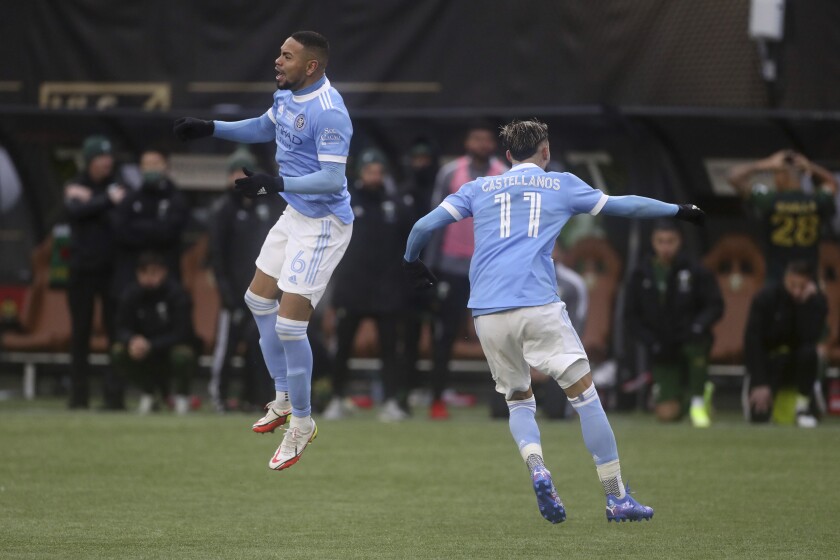 New York City FC's Alexander Callens (6) and Valentin Castellanos (11) celebrate Callen's winning penalty kick during a shootout against the Portland Timbers in the MLS Cup soccer match on Saturday, Dec. 11, 2021, in Portland, Ore. (AP Photo/Amanda Loman)