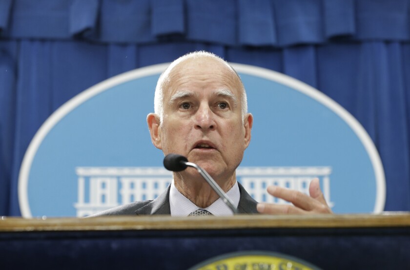 California Gov. Jerry Brown discusses his revised state budget plan during a news conference at the Capitol in Sacramento last month. On Tuesday, Brown and top Democratic lawmakers struck a deal on the budget.