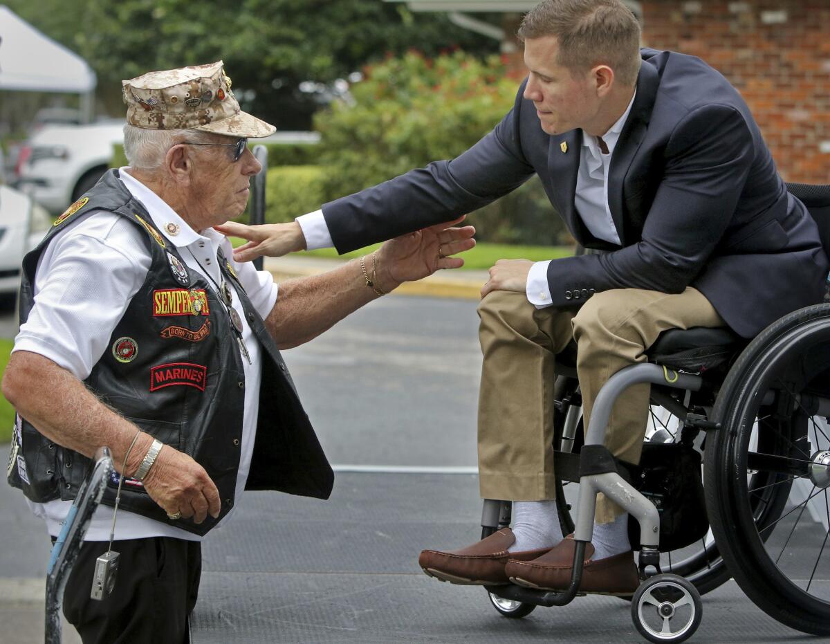 Korean War veteran and Silver Star recipient Alen Elfman, 87, talks with Staff Sgt. Alex Dillmann, who was paralyzed by a roadside bomb in Afghanistan in 2011, in Palm Harbor, Fla.