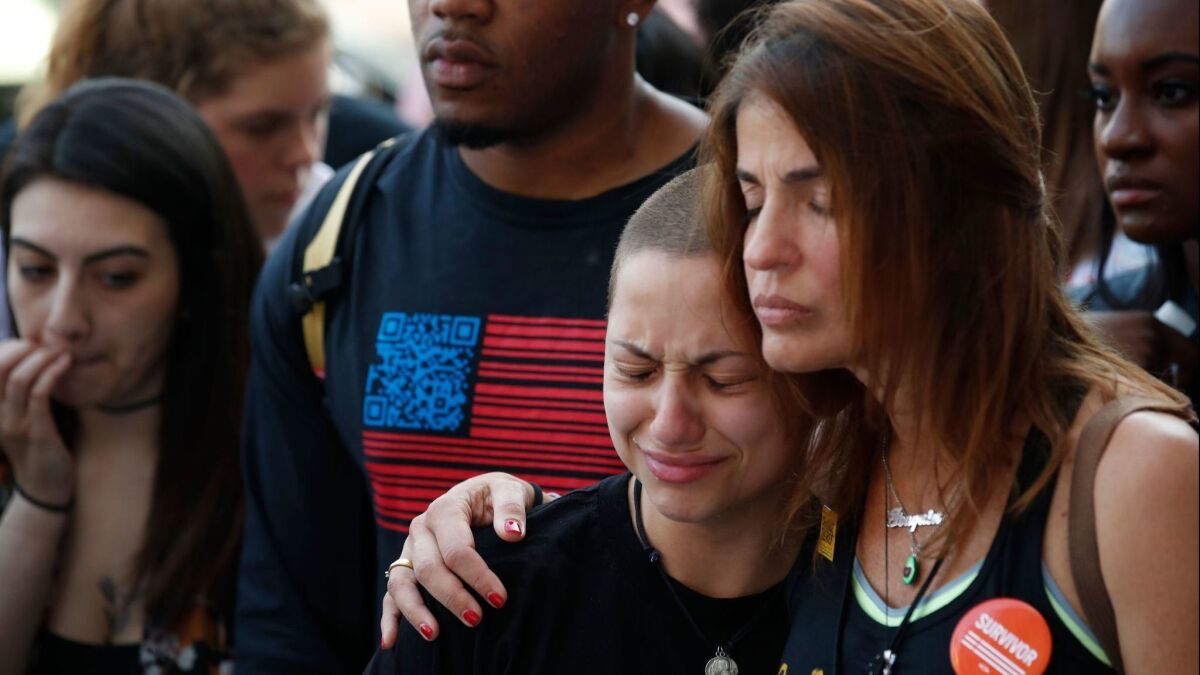 Anti-gun violence advocate and Marjory Stoneman Douglas High School shooting survivor Emma Gonzales, center, is comforted at the End of School Year Peace March and Rally in Chicago on Friday.