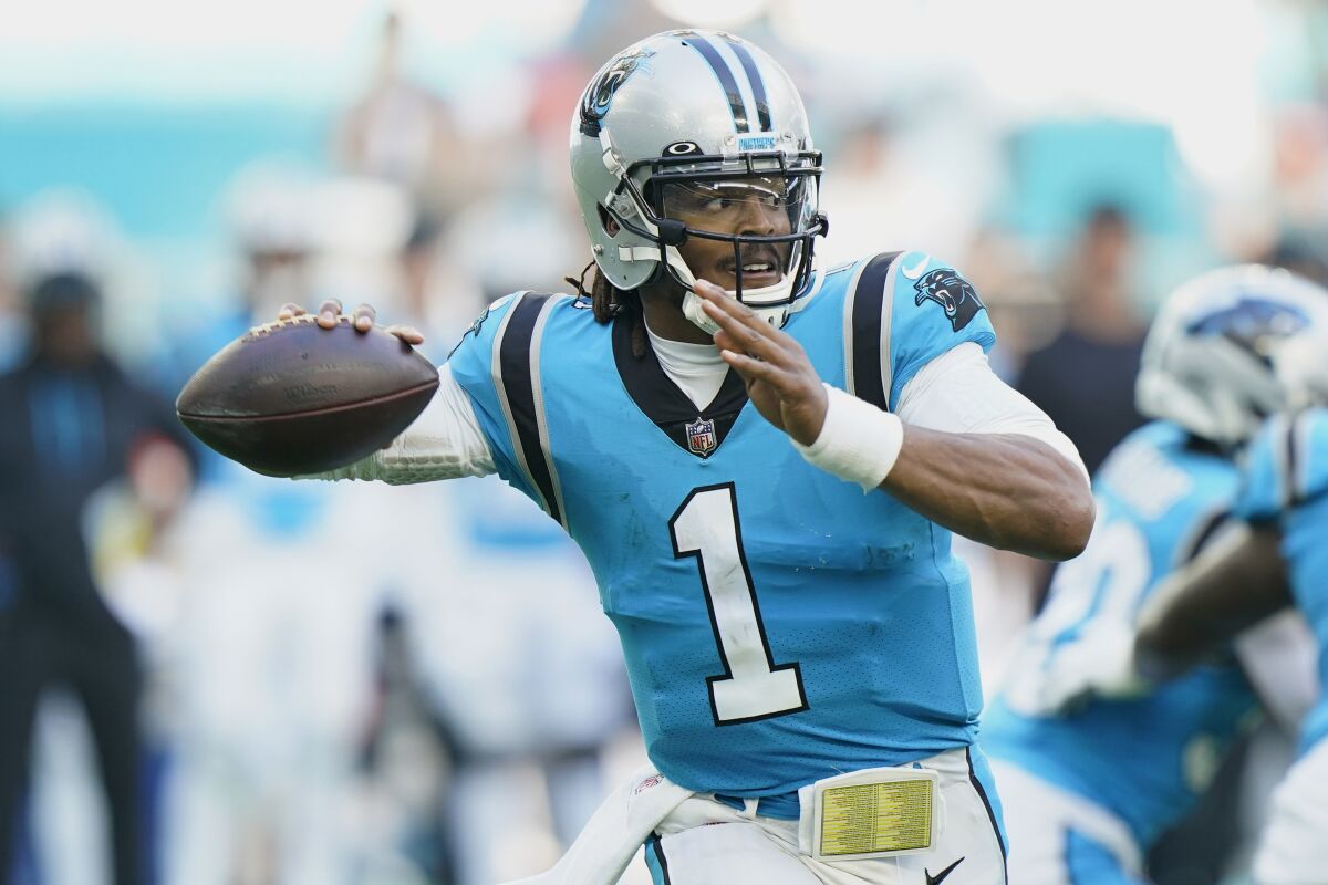 Carolina Panthers quarterback Cam Newton (1) aims a pass during the second half of an NFL football game against the Miami Dolphins, Sunday, Nov. 28, 2021, in Miami Gardens, Fla. (AP Photo/Wilfredo Lee)