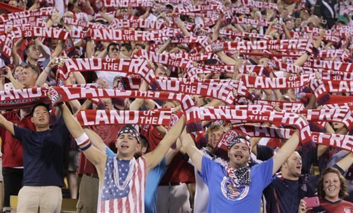 United States fans hold up scarves as they sing the national Anthem before the start of the qualifying soccer match against Mexico in a World Cup, Tuesday, Sept. 10, 2013, in Columbus, Ohio. (AP Photo/Jay LaPrete)