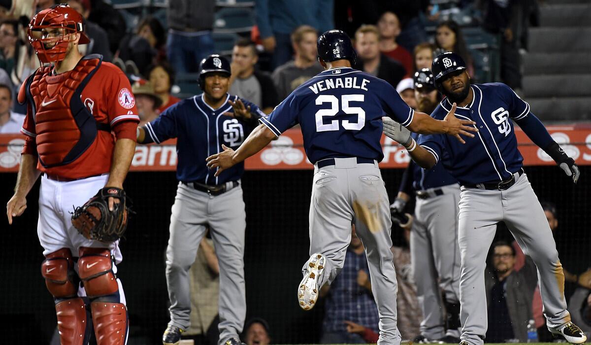 San Diego Padres' Will Venable scores in the tenth inning against the Los Angeles Angels of Anaheim at Angel Stadium on Tuesday. The Padres won the game, 4-0.