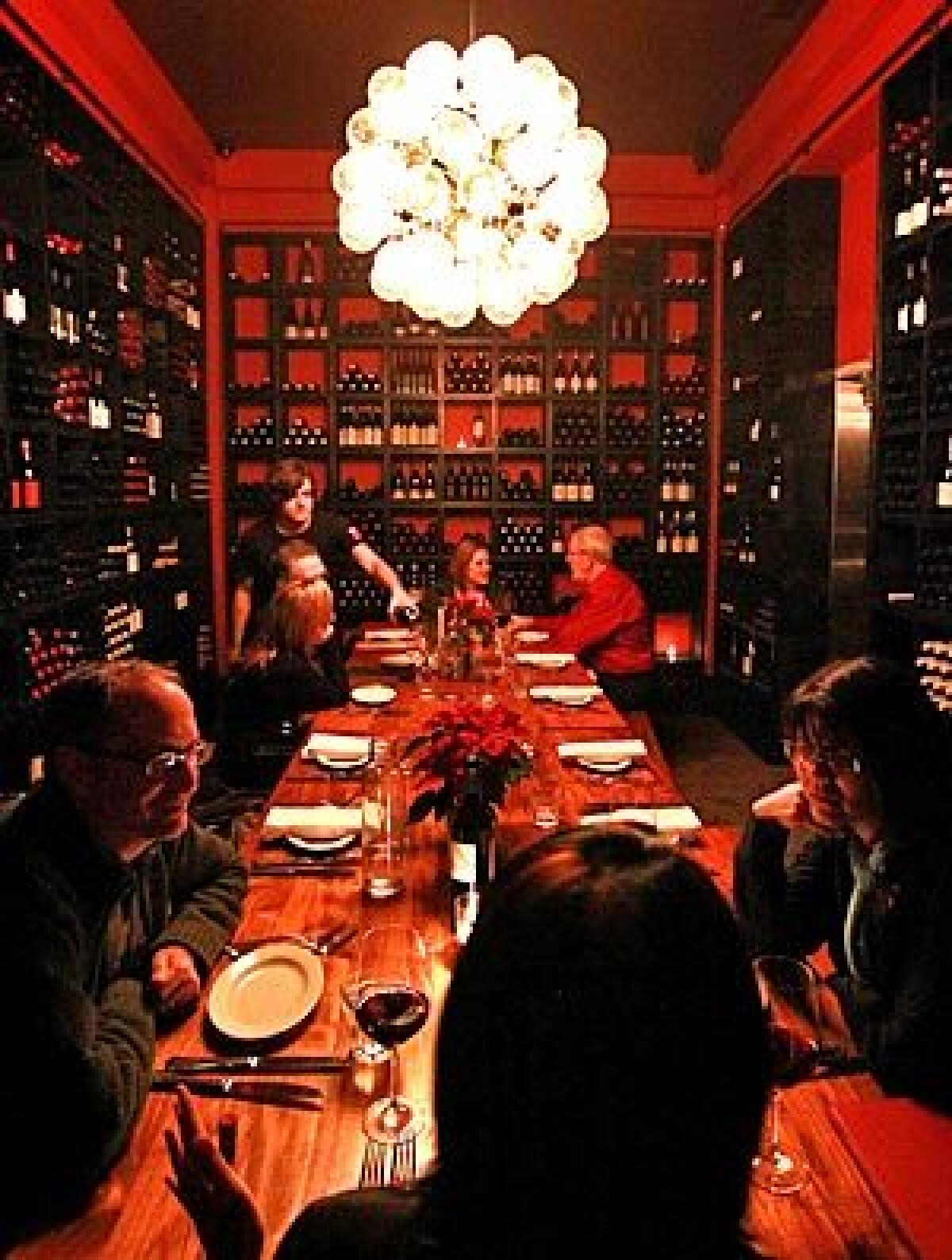 Cube's new wine room has a communal table for dining.