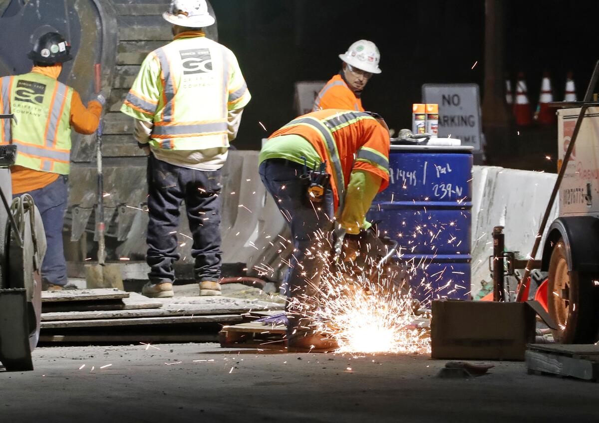 A welder cuts a pipe at the Laguna box culvert construction project in downtown Laguna Beach. 