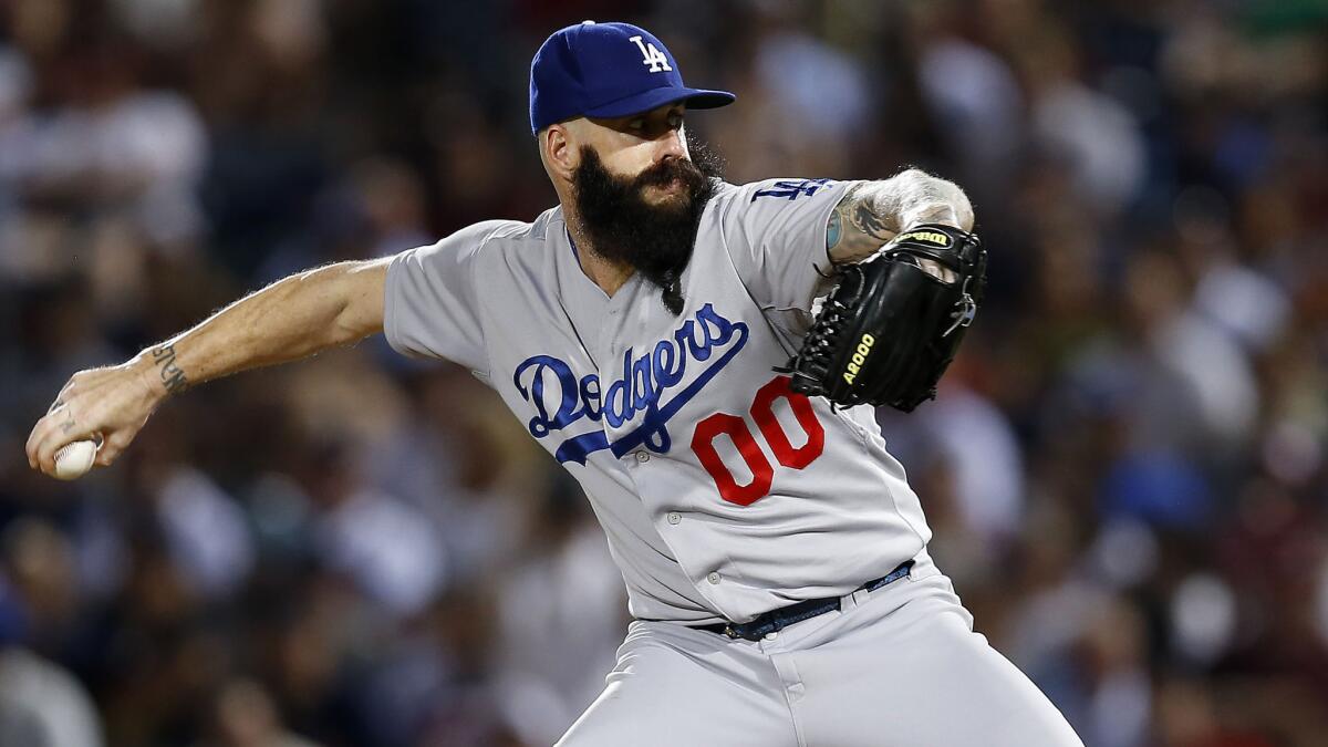 Dodgers reliever Brian Wilson delivers a pitch against the Atlanta Braves on Aug. 12.
