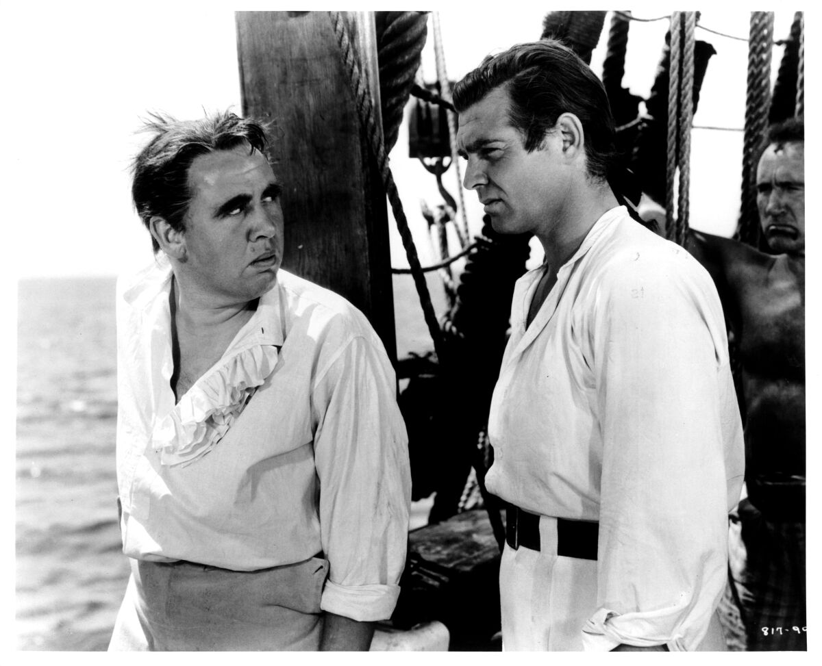 Charles Laughton, left, and Clark Gable standing on deck in “Mutiny on the Bounty” (1935)
