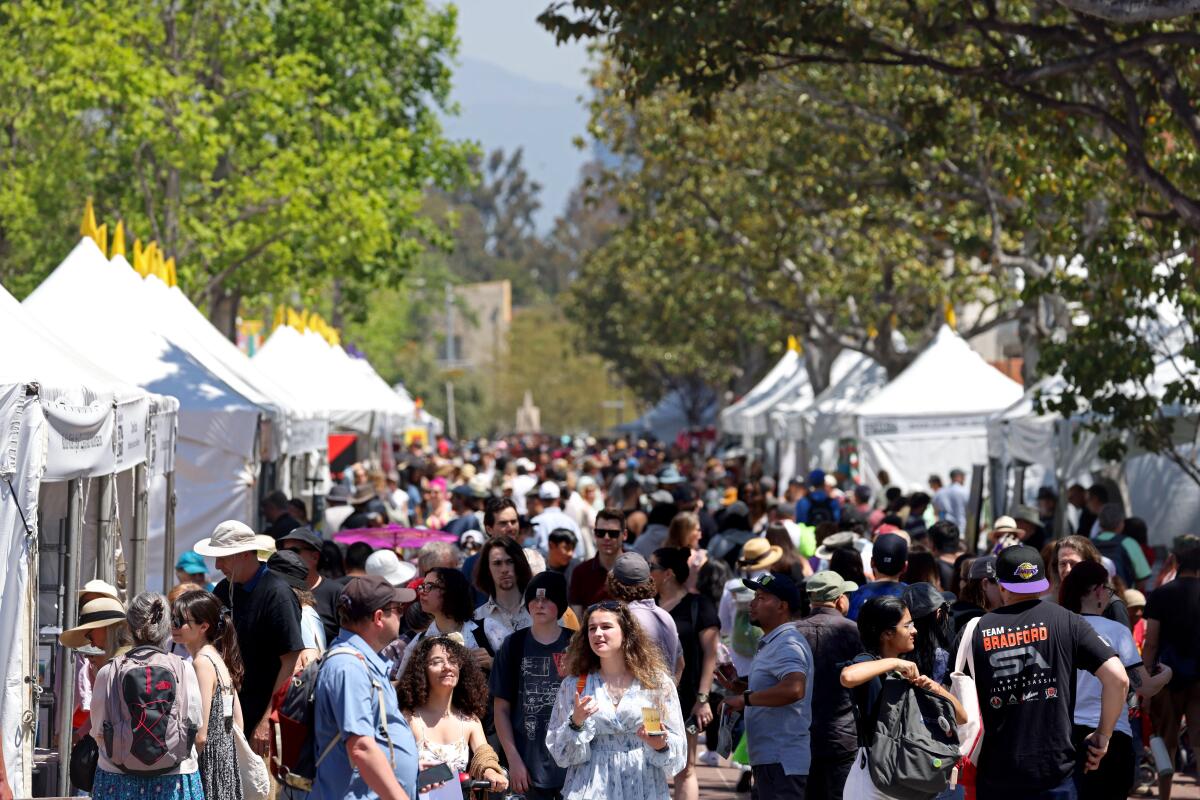 Hundreds of people gather around tents on the campus of USC for the L.A. Times Festival of Books. 