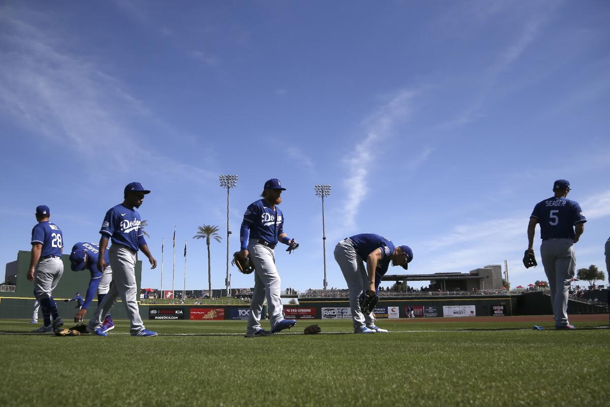 Dodgers players warm up for a spring-training game before they were canceled.