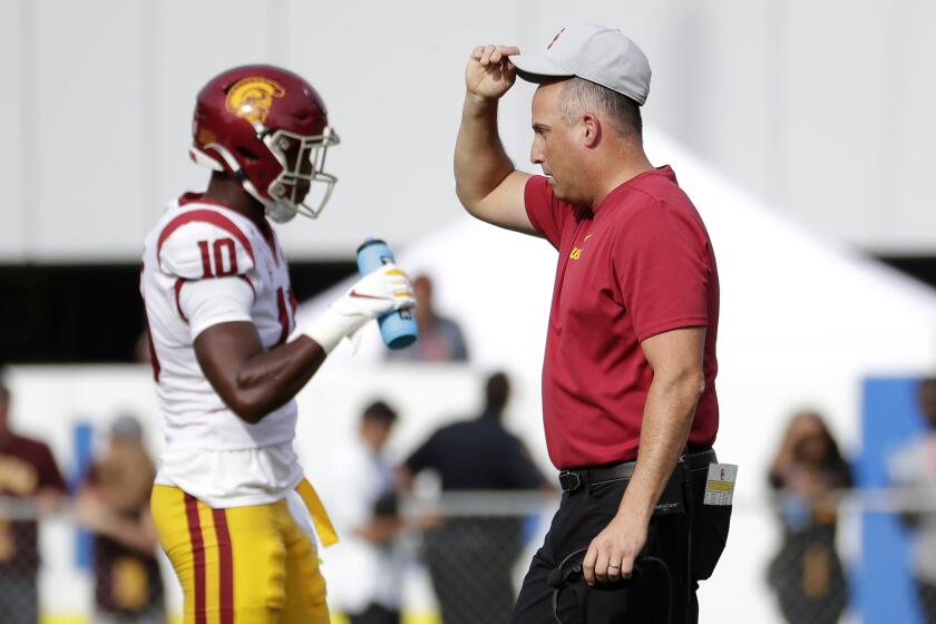 Southern California head coach Clay Helton walks on the field during the first half of an NCAA college football game against Arizona State, Saturday, Nov. 9, 2019, in Tempe, Ariz. (AP Photo/Matt York)