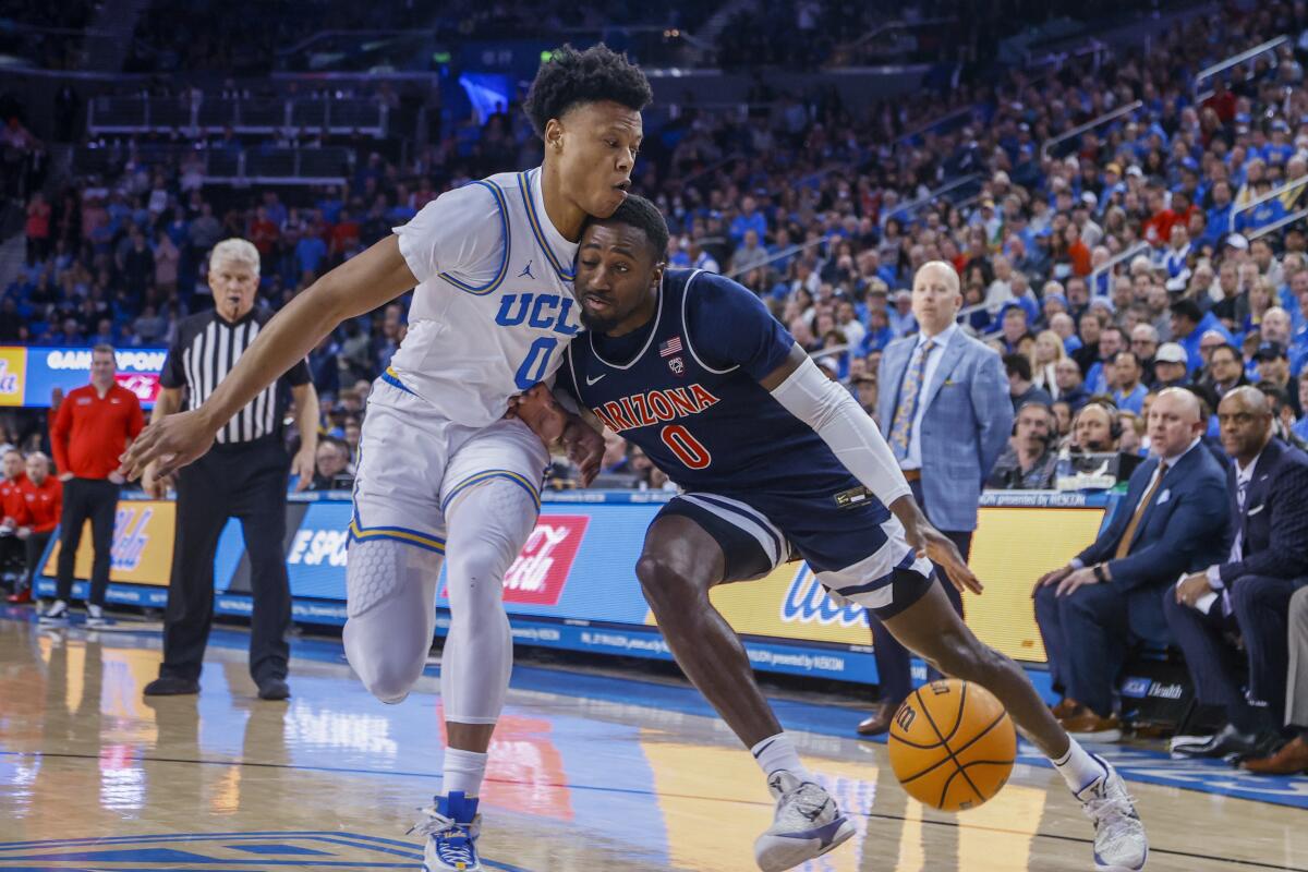 Arizona guard Courtney Ramey, right, drives against UCLA guard Jaylen Clark during the first half of an NCAA college basketball game Saturday, March 4, 2023, in Los Angeles. (AP Photo/Ringo H.W. Chiu)