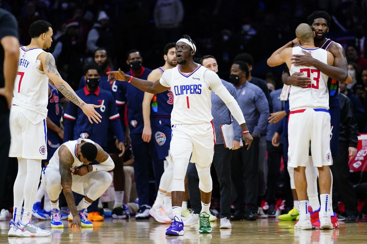 Reggie Jackson (1) celebrates with teammate Amir Coffey (7) after the Clippers rallied to beat the 76ers.