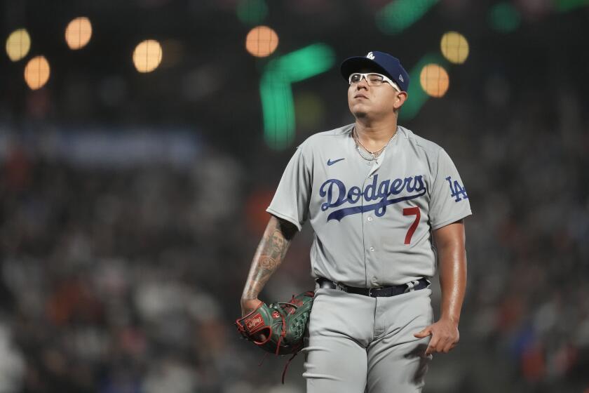 Dodgers pitcher Julio Urias stands on the mound and look forward during a game against the Giants