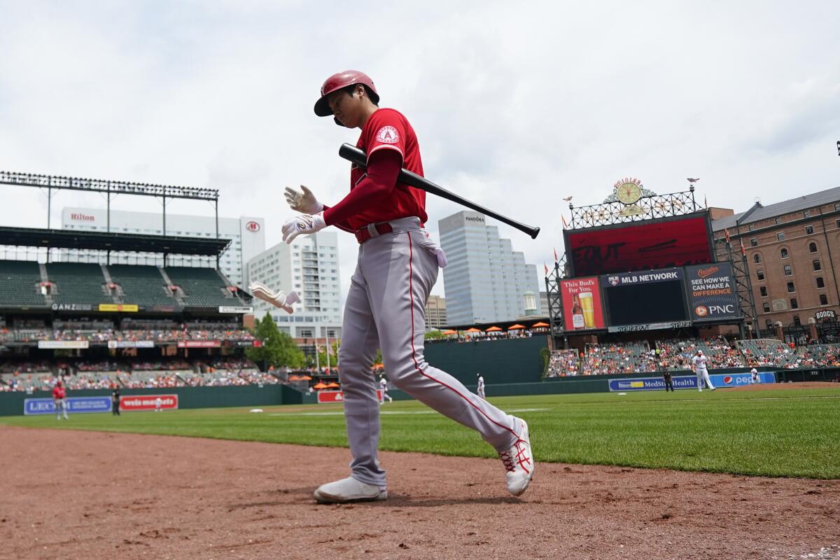Angels designated hitter Shohei Ohtani walks to the dugout after striking out against the Baltimore Orioles.