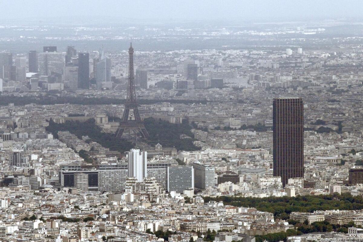 Drones have been spotted in the night sky above Paris landmarks in recent days, including over the Eiffel Tower and the Montparnasse Tower in the right foreground of this 2012 photo.