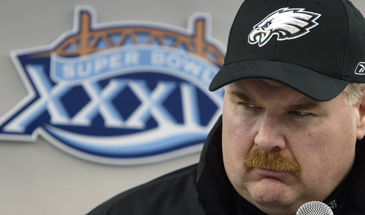 Eagles coach Andy Reid at a microphone next to the Super Bowl XXXIX logo.