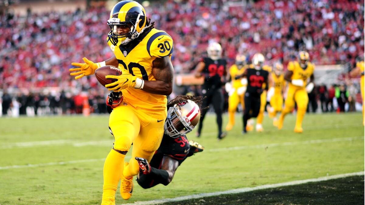 Rams running back Todd Gurley beats 49ers linebacker Ray-Ray Armstrong to the end zone for a touchdown during the first quarter.