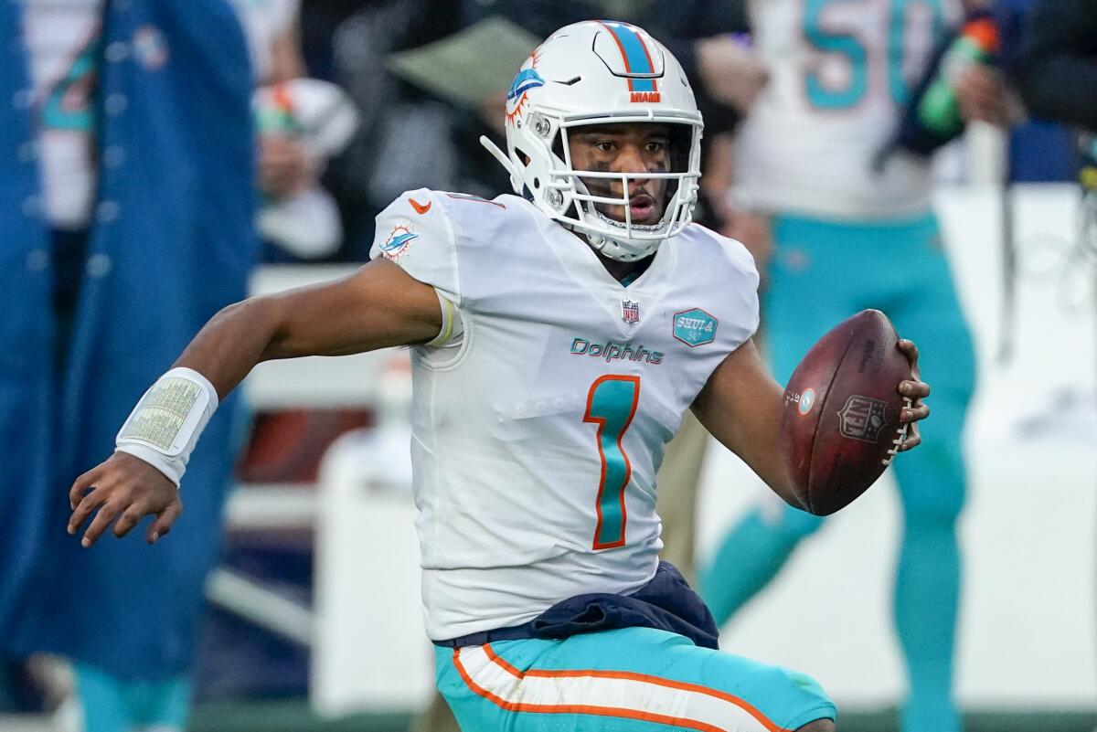 Miami Dolphins quarterback Tua Tagovailoa runs against the Denver Broncos on Sunday.