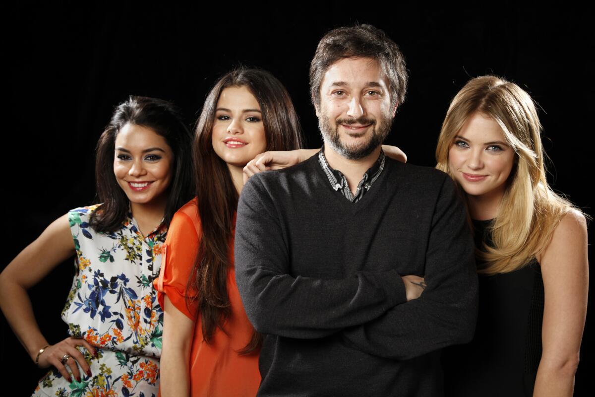 Director Harmony Korine poses for a portrait with three of his four lead actresses from his new film "Spring Breakers": Vanessa Hudgens, left, Selena Gomez and Ashley Benson.