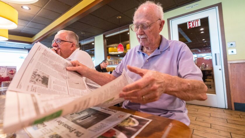 John Brechmann reads the Fresno Bee at Denny's in Fresno recently. Brechmann says the Bee has a liberal bias.