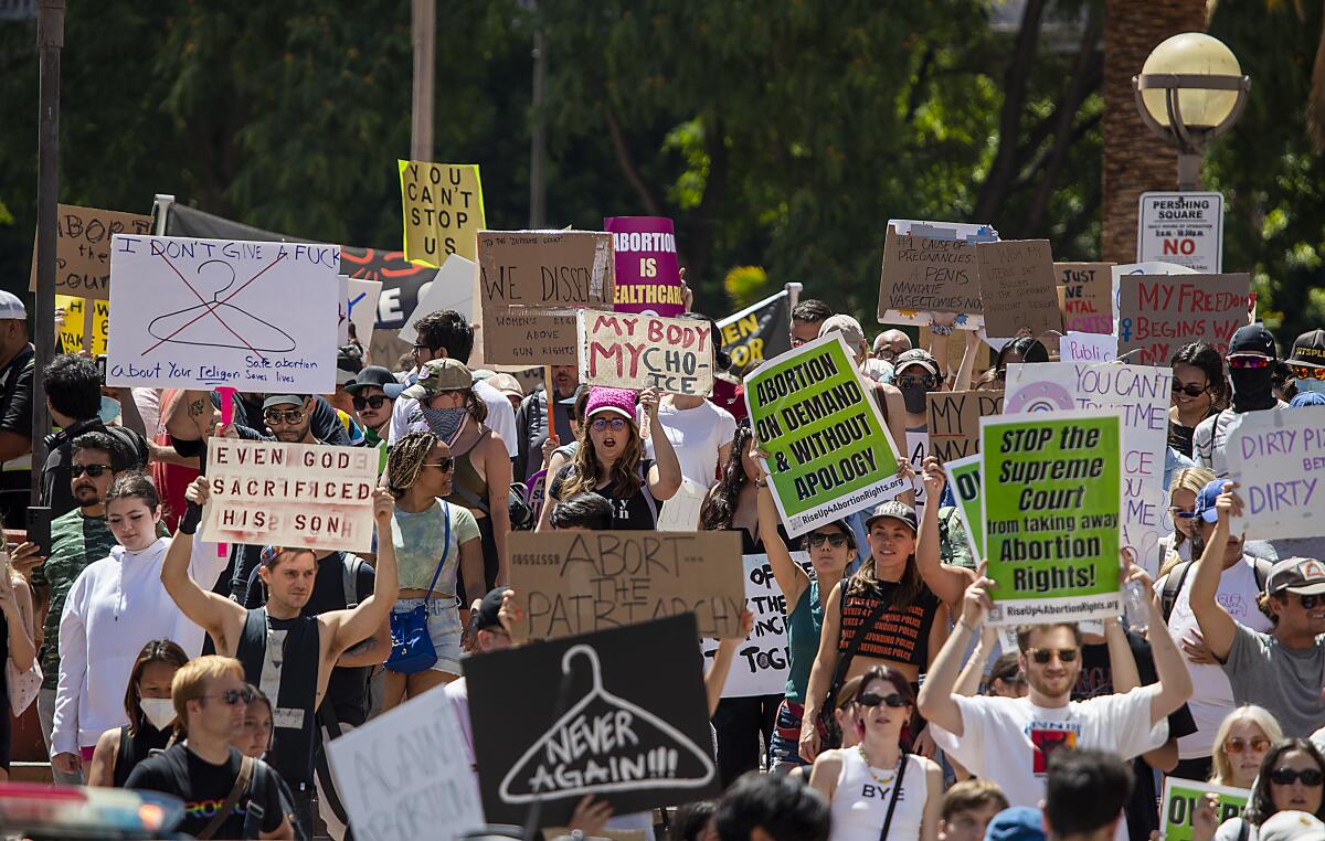 People hold up signs at an abortion rights protest