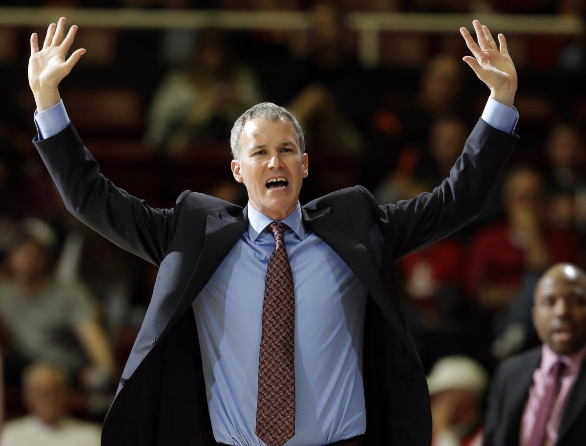USC Coach Andy Enfield throws his hands up as argues a call in a game against Stanford on Sunday.