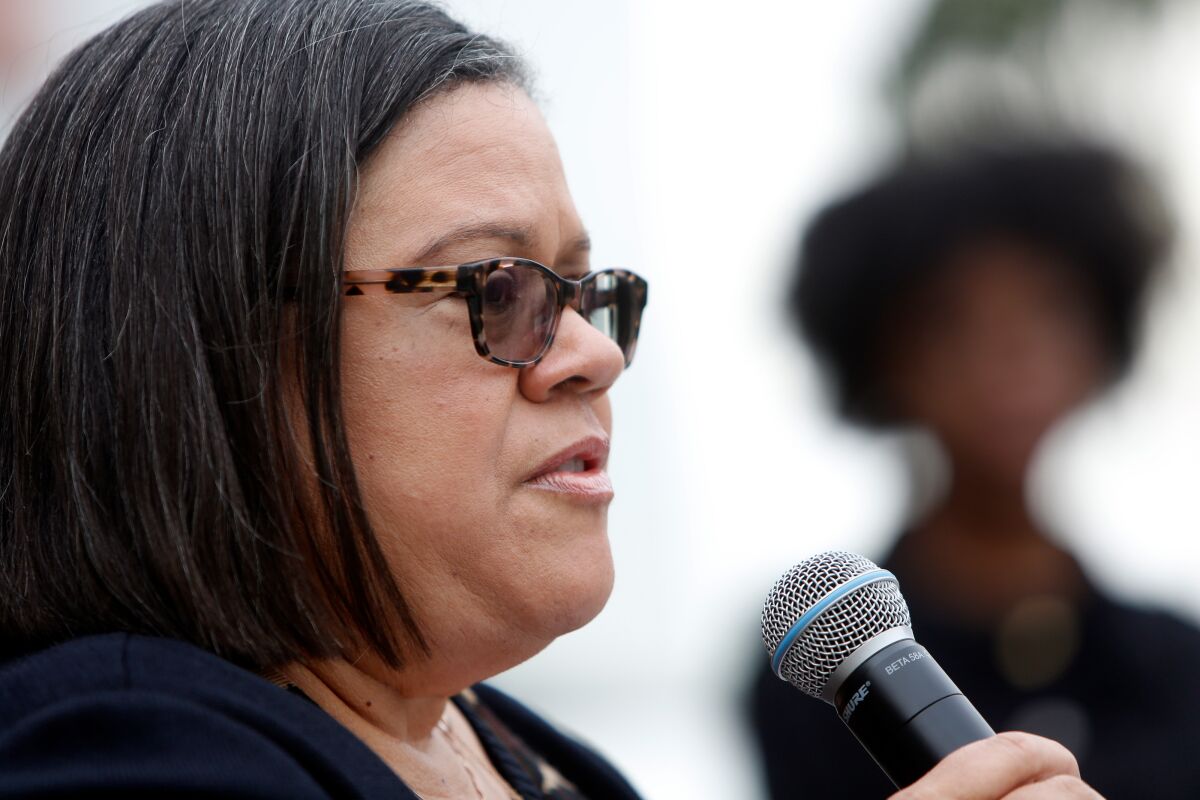 Whittier College President Linda Oubré speaks into a microphone.