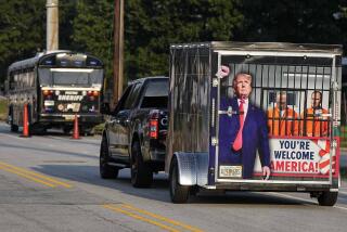 A vehicle and trailer drive by the Fulton County Jail, Thursday, Aug. 24, 2023, in Atlanta. Trump is charged alongside others, who are accused by Fulton County District Attorney Fani Willis of scheming to subvert the will of Georgia voters to keep the Republican president in the White House after he lost to Democrat Joe Biden. (AP Photo/Mike Stewart)