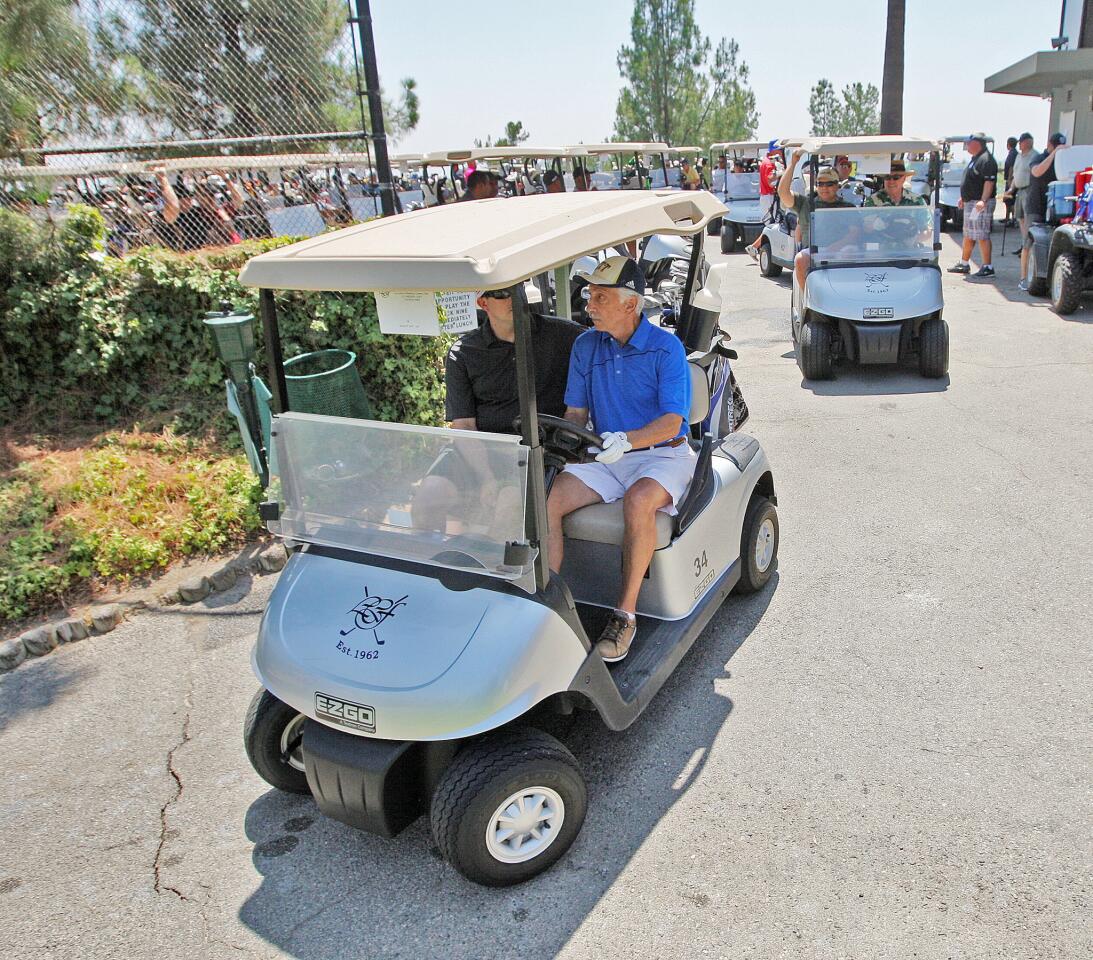 An armada of golf carts begin to depart to their starting hole for a shotgun start at the La Canada Flintridge Country Club on Monday, August 21, 2017.