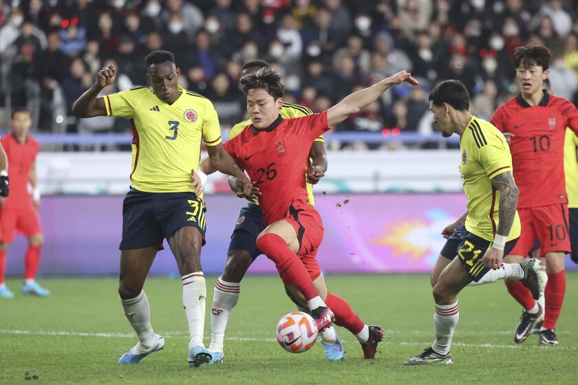 Oh Hyeon-gyu de Corea del Sur pelea para avanzar con el balón mientras lo defiende Jhon Lucumi de Colombia en el encuentro amistoso del viernes 24 de marzo del 2023. (Shin Hyun-woo/Yonhap via AP)