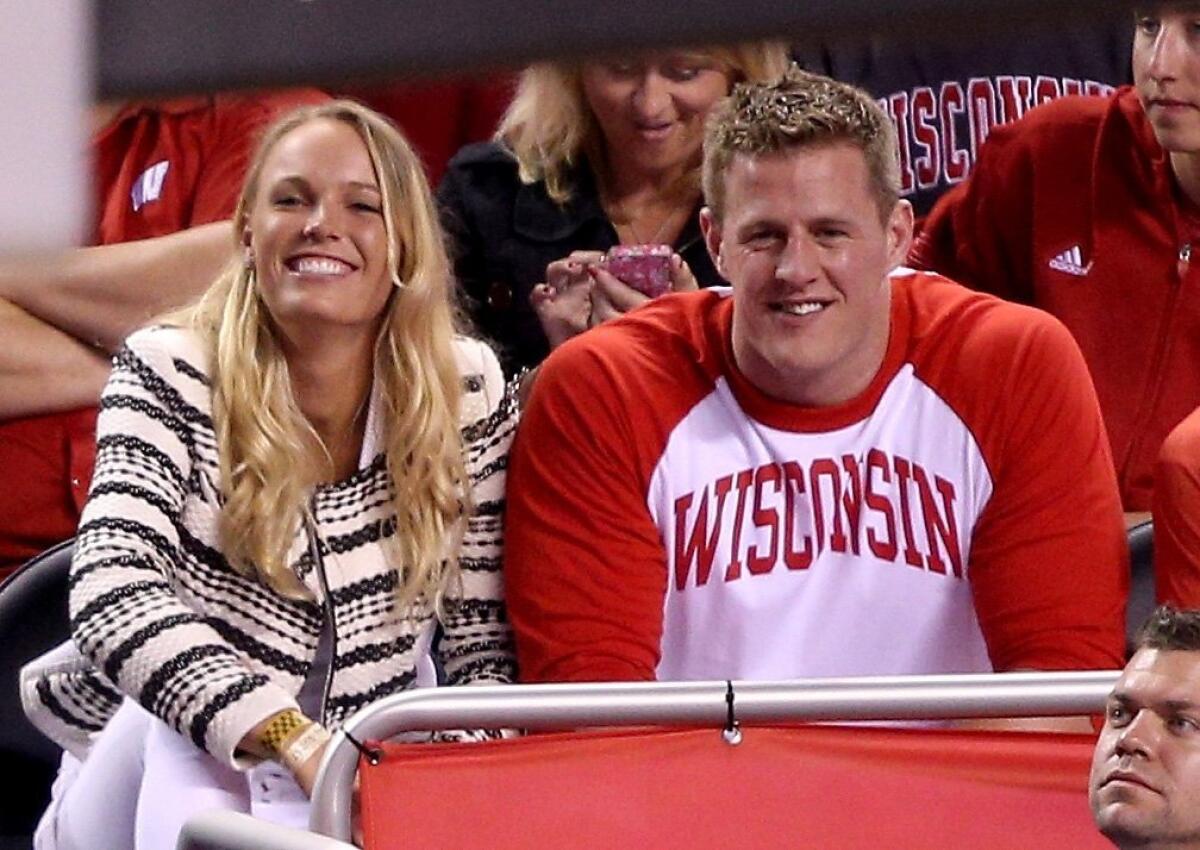Tennis player Caroline Wozniacki and Houston Texans defensive end J.J. Watt in the crowd during the NCAA championship game Monday night between Duke and Wisconsin.