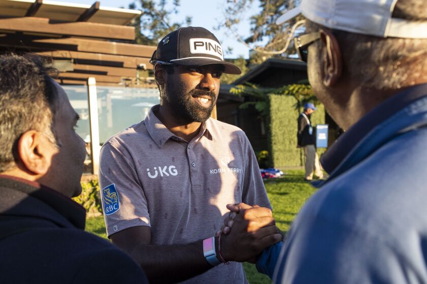 La Jolla, CA - January 27: Sahith Theegala hugs members of his family after the third round of the 2023 Farmers Insurance Open at Torrey Pines Golf Course on Friday, Jan. 27, 2023 in La Jolla, CA. (Meg McLaughlin / The San Diego Union-Tribune)
